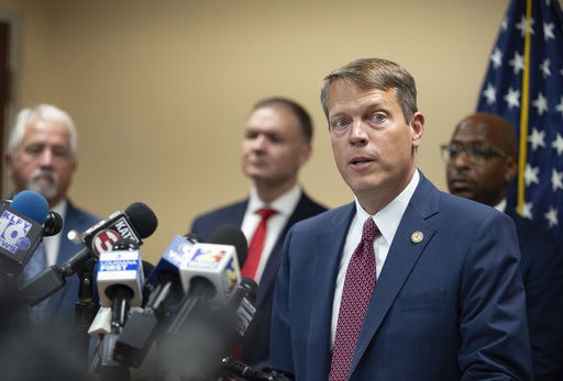 Acting U.S. Attorney Alexander C. Van Hook speaks during a press conference announcing the indictment of current and former police officers on fraud and conspiracy charges