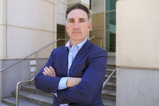 Former federal prosecutor Michael Gordon poses for a photo outside the Sam Gibbons United States Courthouse