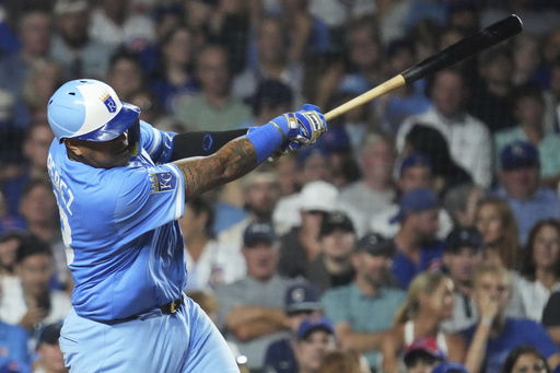 Kansas City Royals' Salvador Perez hits a two-run home run during the eighth inning of a baseball game against the Chicago Cubs in Chicago