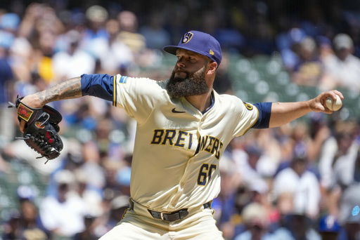 FILE - Milwaukee Brewers starter Dallas Keuchel throws during the first inning of a baseball game