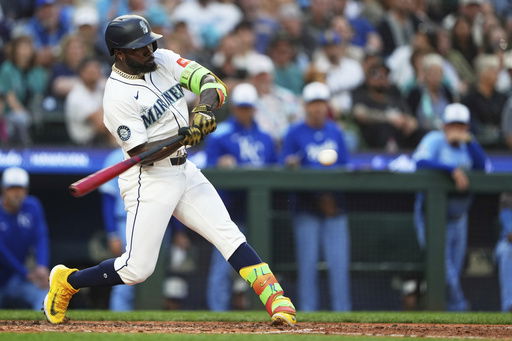 Seattle Mariners' Randy Arozarena hits a solo home run against the Kansas City Royals during the sixth inning of a baseball game Wednesday