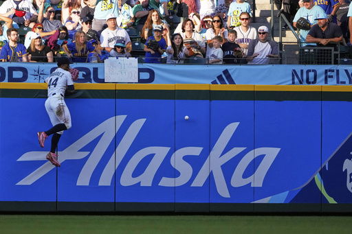 Seattle Mariners center fielder Julio Rodriguez misjudges a ball hit by Kansas City Royals' Salvador Perez to allow a two-run double during the fifth inning of a baseball game Tuesday