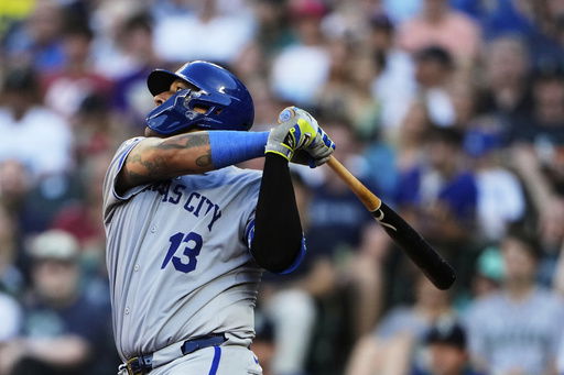 Kansas City Royals' Salvador Perez follows through on a two-run double to score Bobby Witt Jr. and Vinnie Pasquantino against the Seattle Mariners during the fifth inning of a baseball game Tuesday