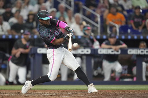 Miami Marlins' Otto Lopez hits a double to bring in two runs in the eighth inning of a baseball game against the Kansas City Royals