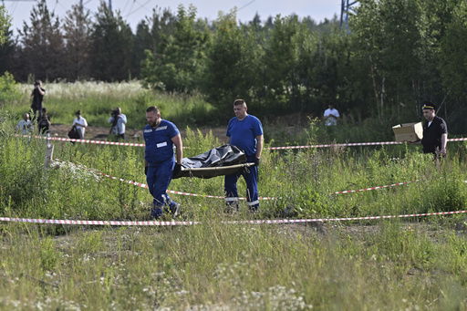 Russian law enforcement agents carry the body of former Transportation Minister Roman Starovoit