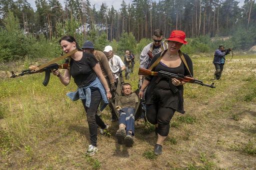 Civilians practice military skills on a training ground in Kharkiv