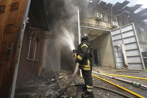 Firefighters tackle the blaze after a Russian attack that hit a residential area in Kharkiv