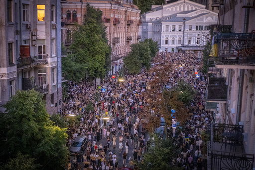Thousands of people protest against a law targeting anti-corruption institutions near the President's Office in Kyiv