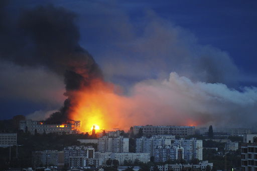 FILE - Fire and smoke rise from the site where a Russian missile struck a residential area in Kharkiv