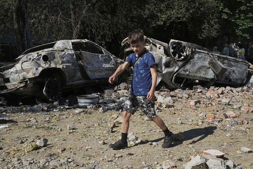 Damaged cars lie in a yard among other debris after a Russian drone and missile attacks in Kyiv