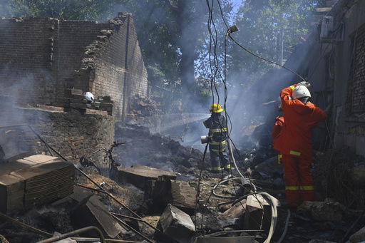 Emergency services personnel work to extinguish a fire following a Russian attack in Odesa