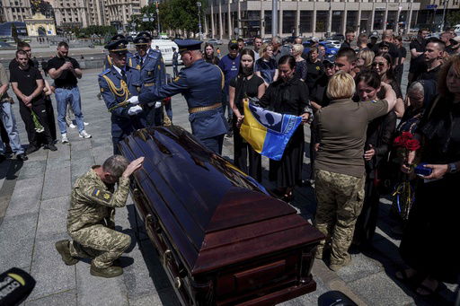 A Ukrainian serviceman says goodbye to Ukrainian F-16 pilot Maksym Ustymenko