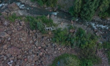 A tour company Jeep sits near Canyon Creek after traveling off a cliff on Camp Bird Road in September 2022. Three people were killed in the crash. The families of two women who were passengers in the tour are suing the driver's estate
