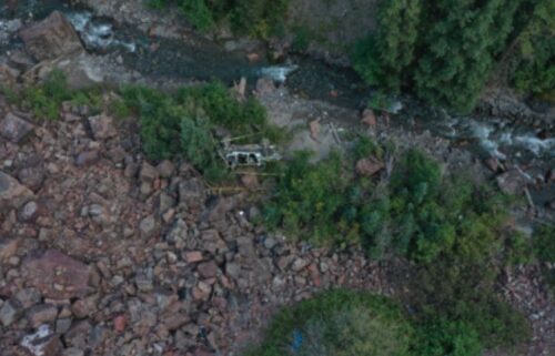 A tour company Jeep sits near Canyon Creek after traveling off a cliff on Camp Bird Road in September 2022. Three people were killed in the crash. The families of two women who were passengers in the tour are suing the driver's estate