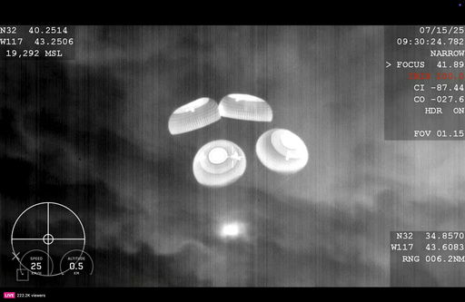 This image made from video provided by SpaceX shows a SpaceX capsule carrying four astronauts parachuting into the Pacific Ocean off the coast of Southern California on Tuesday