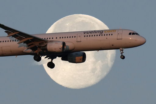 FILE - A Vueling Airbus A321 approaches for landing in Lisbon at sunrise
