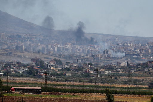 Smoke rise from clashes between Syrian government forces and Druze militias in Sweida city