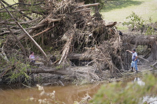 People search along the Guadalupe River after flooding in Kerrville