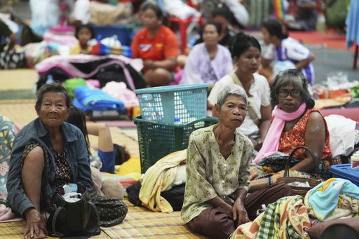 Thai residents who fled homes following clashes between Thai and Cambodian soldiers rest at an evacuation center in Surin province