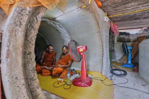 Thai Buddhist monks who fled clashes between Thai and Cambodian soldiers take shelter in Surin province