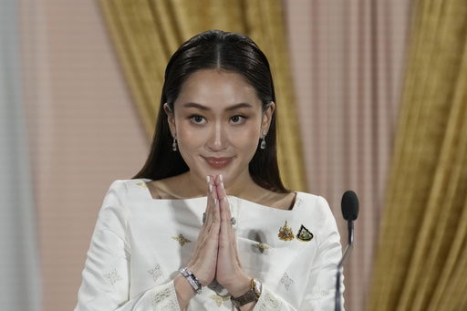 FILE - Thailand's new Prime Minister Paetongtarn Shinawatra talks to media members after receiving a royal letter of endorsement for the post at the Pheu Thai party headquarters in Bangkok