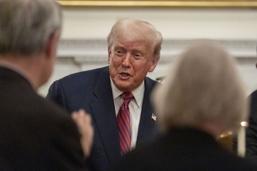 President Donald Trump greets supporters during a dinner for Republican senators in the State Dining Room of the White House