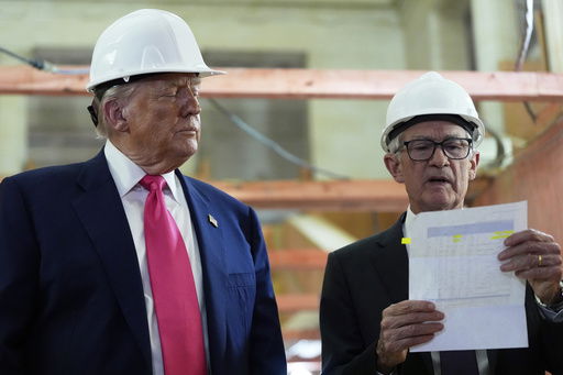 Federal Reserve Chairman Jerome Powell looks over a document of cost figures as President Donald Trump watches during a visit to the Federal Reserve