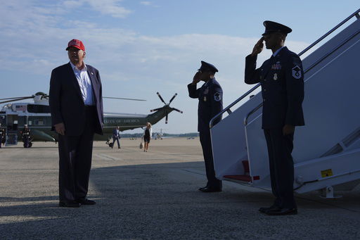 President Donald Trump boards Air Force One for a trip to visit a new migrant detention center in Ochopee