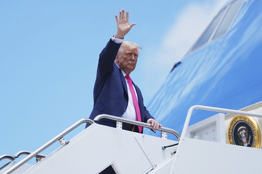 President Donald Trump gestures as he boards Air Force One