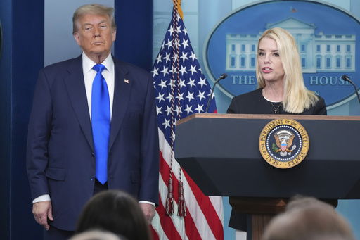 Attorney General Pam Bondi speaks to reporters as President Donald Trump listens