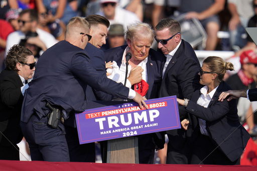 FILE - Republican presidential candidate former President Donald Trump is helped off the stage at a campaign event in Butler