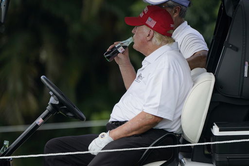 FILE - Former President Donald Trump drinks a Diet Coke during the ProAm of the LIV Golf Team Championship at Trump National Doral Golf Club
