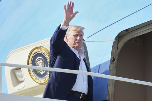 President Donald Trump waves as he boards Air Force One
