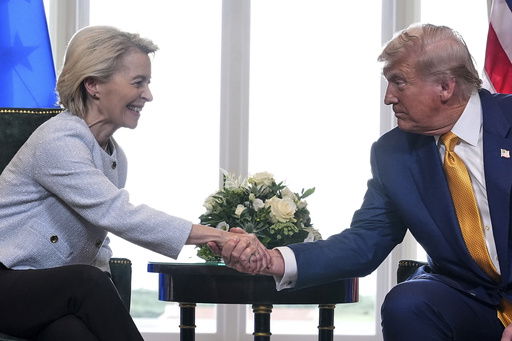 President Donald Trump and European Commission President Ursula von der Leyen shake hands after reaching a trade deal at the Trump Turnberry golf course in Turnberry