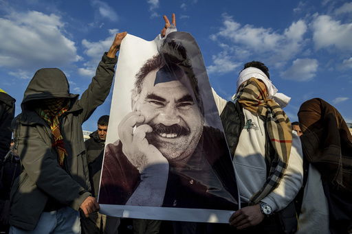 FILE - Youngsters hold a photograph of Abdullah Ocalan