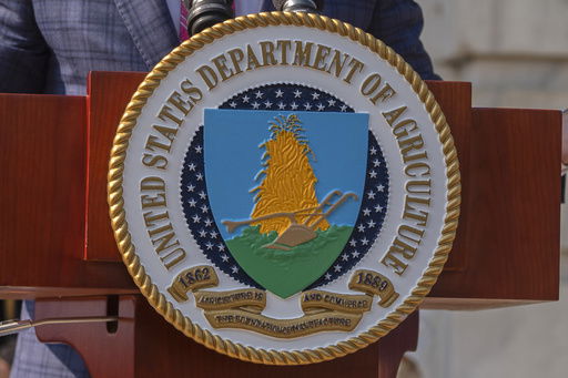 FILE - The U.S. Department of Agriculture seal is seen on a podium during a news conference in Washington