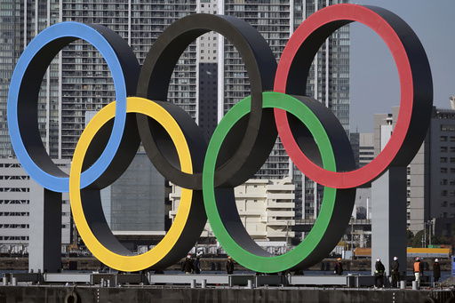 FILE - The Olympic rings are reinstalled after being taken down for maintenance ahead of the postponed Tokyo 2020 Olympics in the Odaiba section in Tokyo