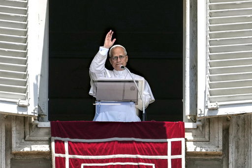 Pope Leo XIV appears at his studio's window to bless the faithful gathered in St. Peter's Square at the Vatican for the Angelus prayer