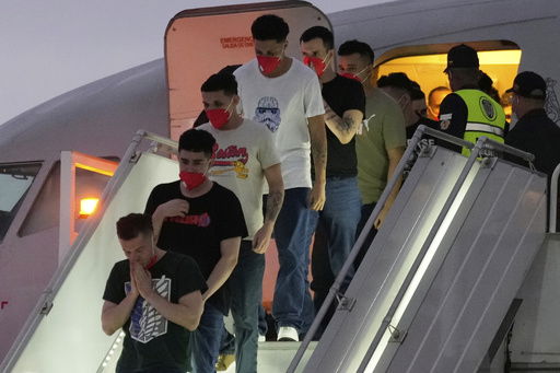 Migrants deported months ago by the United States to El Salvador under the Trump administration's immigration crackdown arrive at Simon Bolívar International Airport in Maiquetia