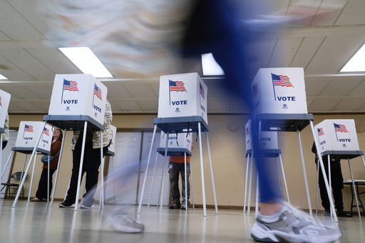 FILE - People vote