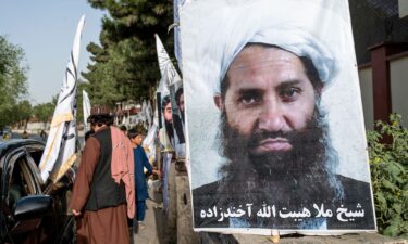A poster of Taliban Supreme Leader Hibatullah Akhundzada is seen along a road in Kabul on August 14