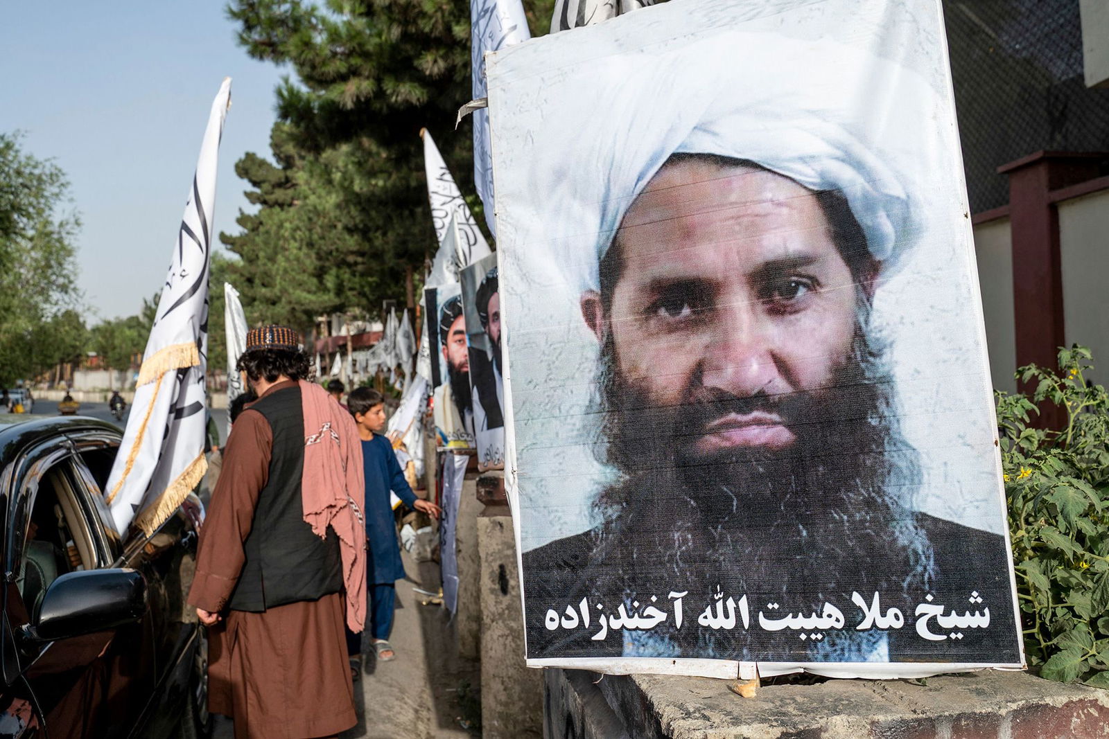 <i>Wakil Kohsar/AFP/Getty Images via CNN Newsource</i><br/>A poster of Taliban Supreme Leader Hibatullah Akhundzada is seen along a road in Kabul on August 14