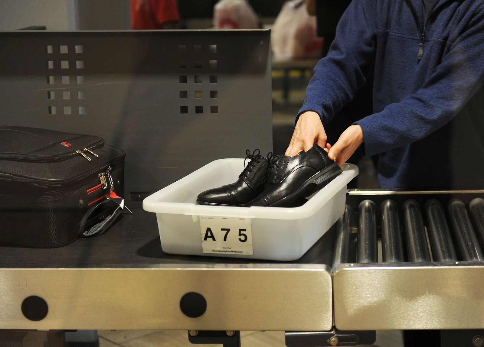<i>Robyn Beck/AFP/Getty Images/FILE via CNN Newsource</i><br/>An air traveler places his shoes in a bin before passing through a TSA checkpoint at Los Angeles International Airport in 2014.