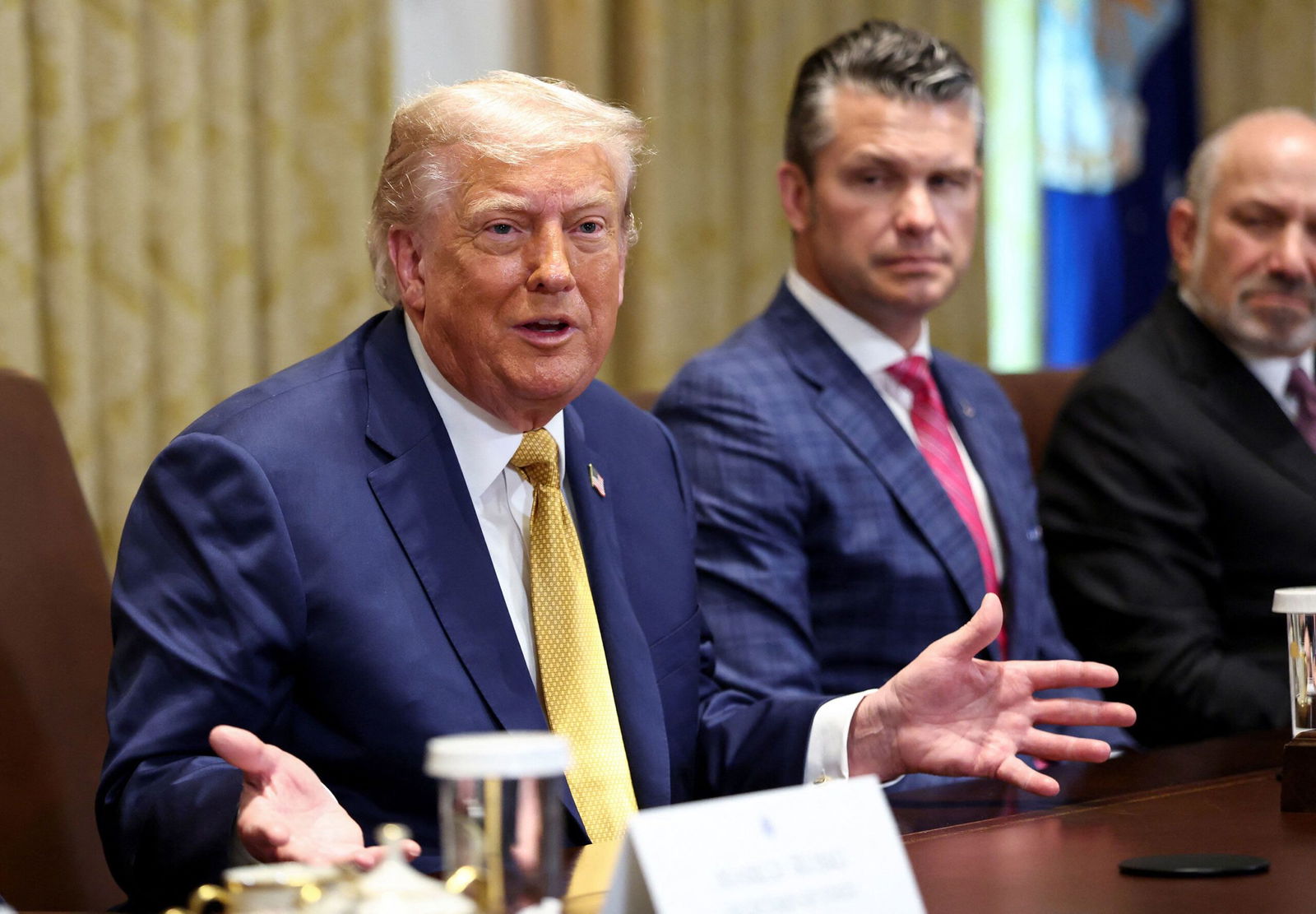 <i>Kevin Lamarque/Reuters via CNN Newsource</i><br/>President Donald Trump speaks next to Defense Secretary Pete Hegseth during a Cabinet meeting at the White House in Washington