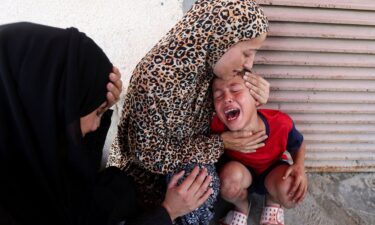 Relatives mourn over the bodies of Manal Abd Rabbo and her sister Fatima