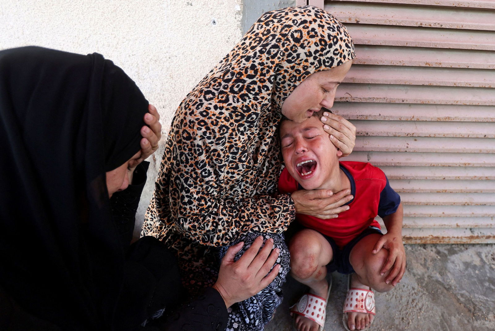 <i>Abdel Kareem Hana/AP via CNN Newsource</i><br/>Relatives mourn over the bodies of Manal Abd Rabbo and her sister Fatima