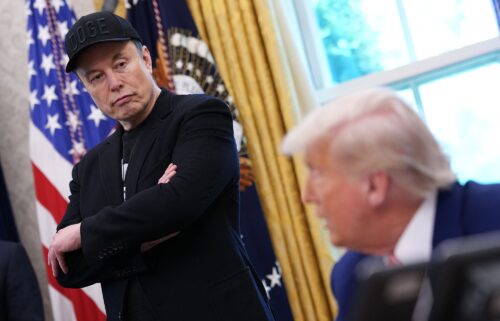 Elon Musk listens as President Donald Trump speaks to reporters in the Oval Office of the White House earlier this year.