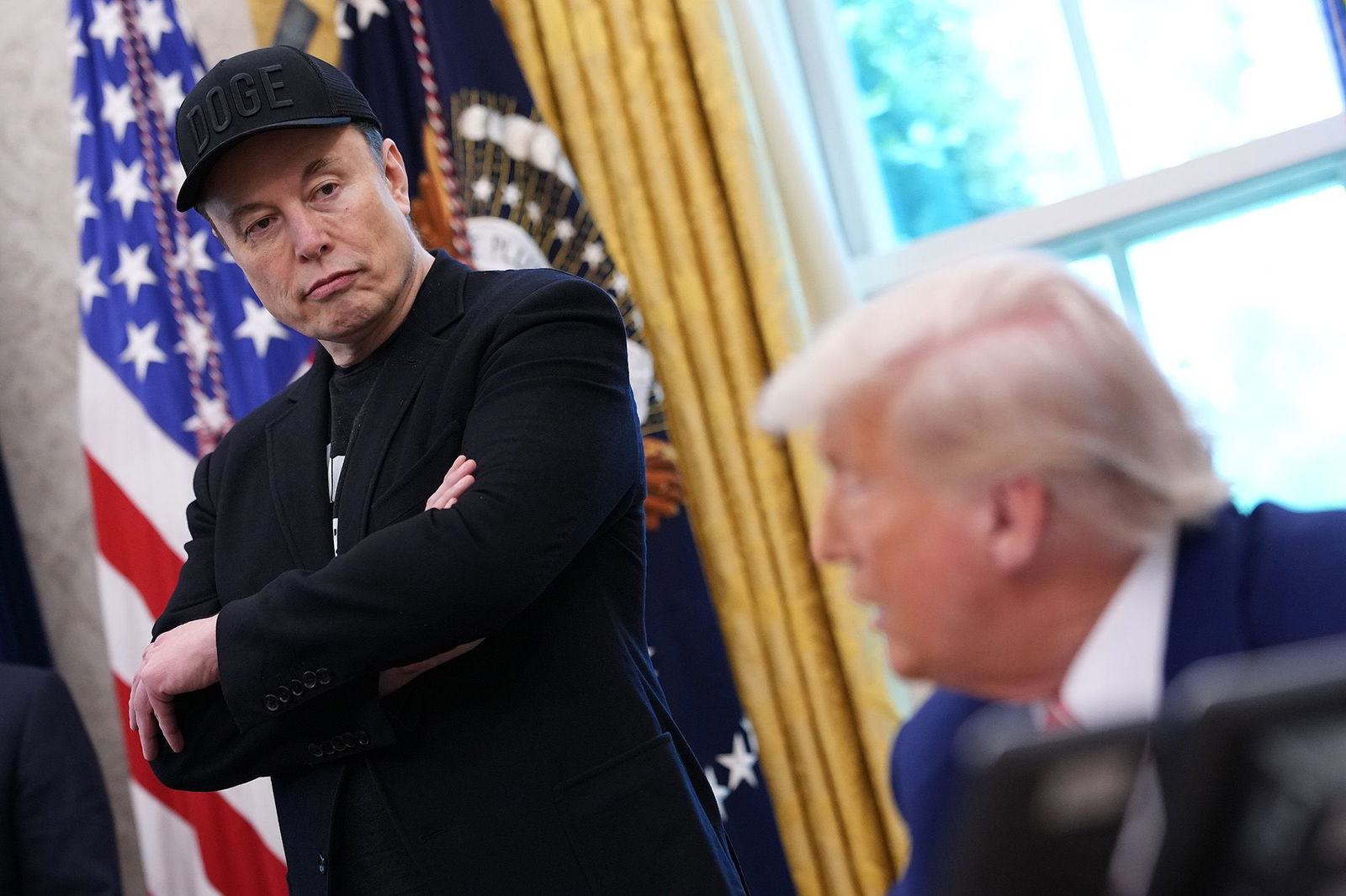 <i>Kevin Dietsch/Getty Images via CNN Newsource</i><br/>Elon Musk listens as President Donald Trump speaks to reporters in the Oval Office of the White House earlier this year.