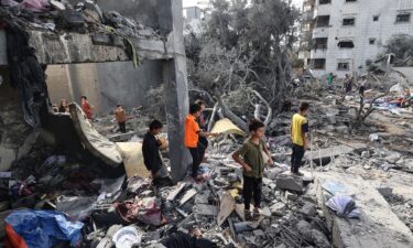 Palestinian children check the rubble of a residential house in Deir el-Balah in the central Gaza Strip on July 1