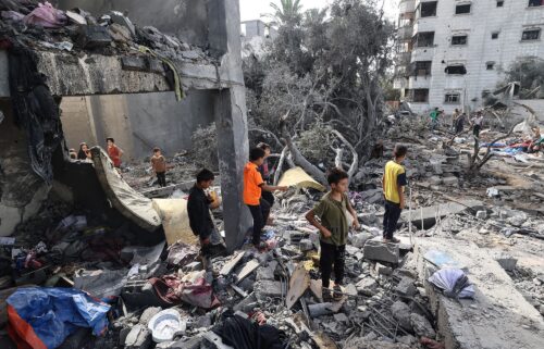 Palestinian children check the rubble of a residential house in Deir el-Balah in the central Gaza Strip on July 1
